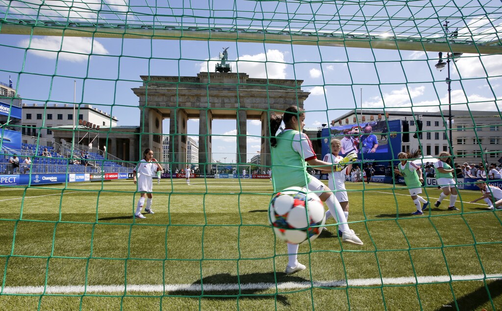 Pupils of girls soccer teams from Berlin schools play soccer at the UEFA Champions Festival in front of the Brandenburg Gate in Berlin, Germany, June 4, 2015. The Olympic stadium will host Saturday's Champions League final between Barcelona and Juventus in Berlin women men female male girls boys teenagers teens development gender gap parity equality diversity progress change femmine masuline woman man sex biology roles dynamic balance bias androgynous sports children child kids parent mother father soccer game sport