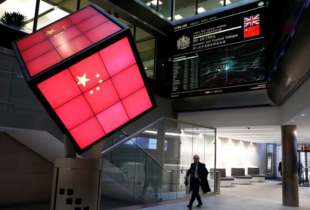 An illuminated cube bearing the Chinese flag is seen in the entrance foyer of the London Stock Exchange in London