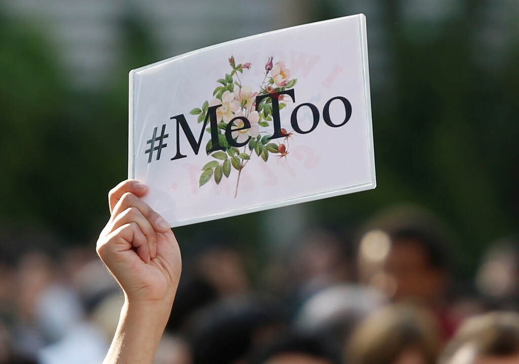 A protester raises a placard reading "#MeToo" during a rally against harassment at Shinjuku shopping and amusement district in Tokyo, Japan, April 28, 2018. Picture taken April 28, 2018. REUTERS/Issei Kato - RC19441C57D0