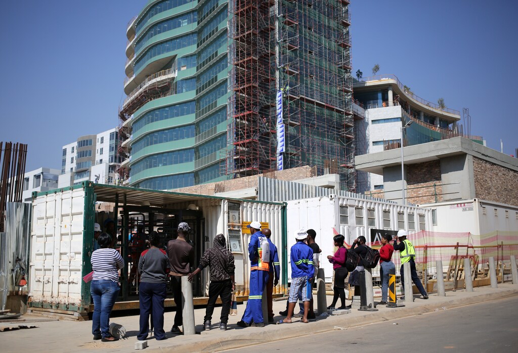 Job seekers are seen outside a construction site in Sandton, an affluent area situated within the metro of Johannesburg, South Africa September 8, 2017. Picture taken September 8, 2017. REUTERS/Siphiwe Sibeko