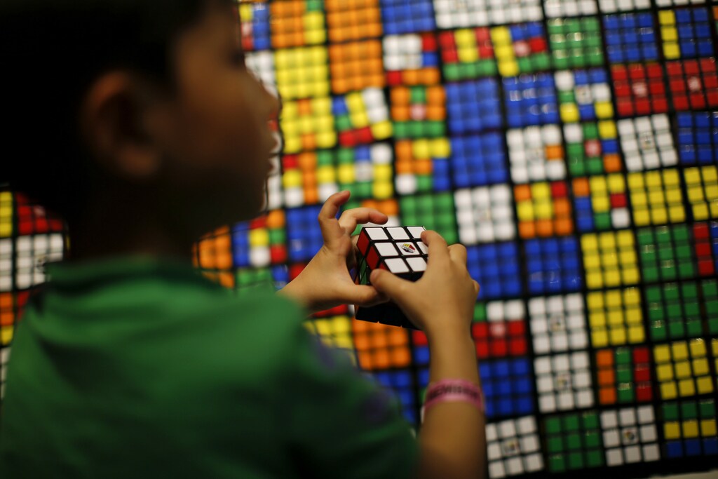 A boy plays with the Rubik's cube during an event to mark the 40th anniversary of the puzzle toy at the Liberty Science Center in Jersey City, New Jersey, April 26, 2014. REUTERS/Eduardo Munoz (UNITED STATES - Tags: SOCIETY ANNIVERSARY) - GM1EA4R0B2Z01