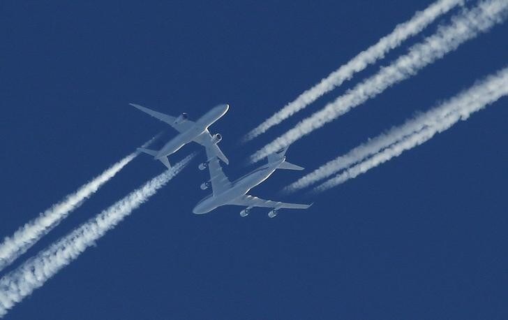Two airliners pass in the sky above Malta as the drama of a hijacked Libyan Afriqiyah Airways Airbus A320 is played out on the runway beneath at Malta Airport, December 23, 2016. REUTERS/Darrin Zammit-Lupi MALTA OUT