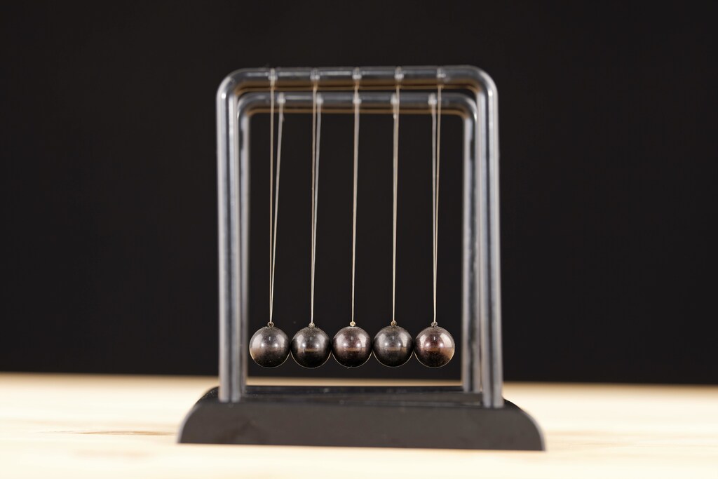Metal Newton's cradle isolated on white background.