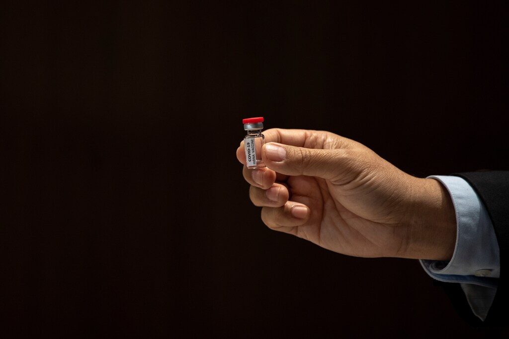 A researcher holds up an mRNA type vaccine candidate for the coronavirus disease (COVID-19) during a news conference at the National Primate Research Center of Chulalongkorn University in Saraburi province, Thailand, June 22, 2020