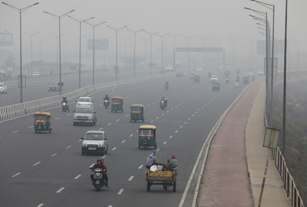 Vehicles are seen on a highway on a smoggy morning in New Delhi, India.