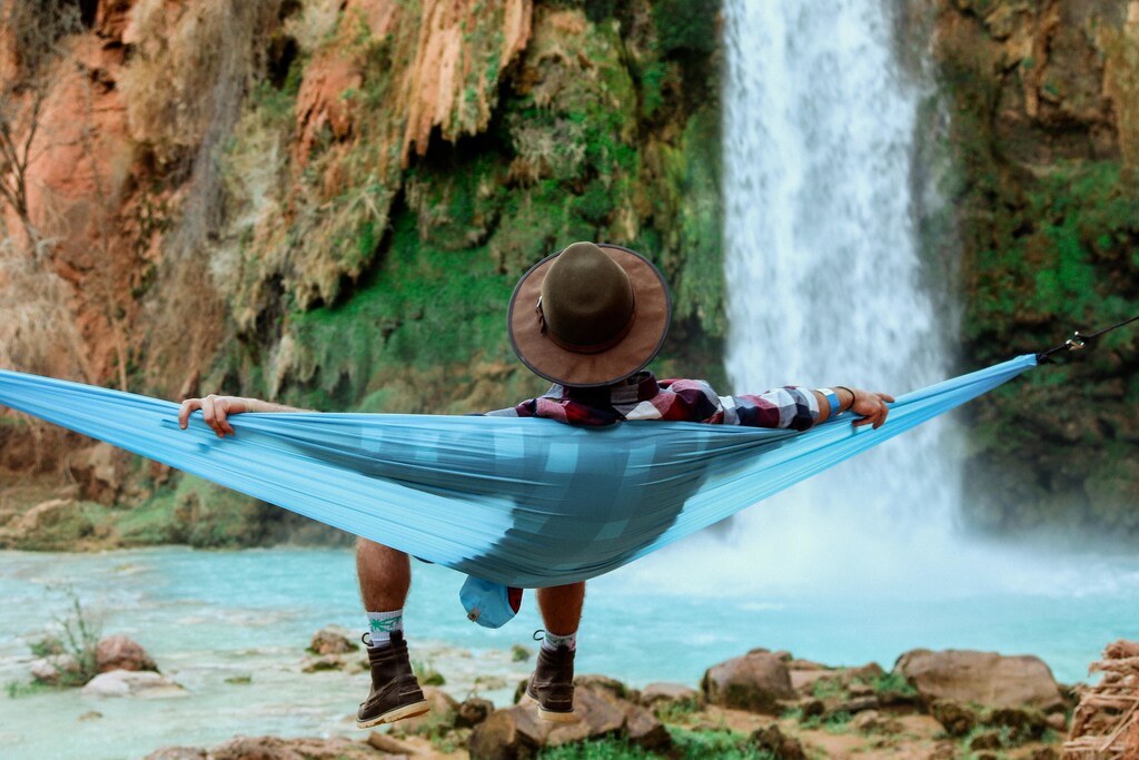 a list of songs has been created which are scientifically proven to help people relax, like this man lying back in a hammock
