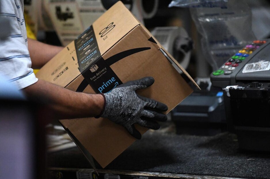 A worker assembles a box for delivery at the Amazon fulfillment center in Baltimore, Maryland. REUTERS