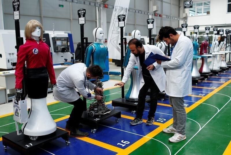 Ozgur Akin, Chairman and founder of Akinsoft, and engineers check an "ADA G4" humanoid robot at Akinrobotics, the country's first-ever factory to mass produce humanoid robots, in Konya, Turkey, December 8, 2017. Picture taken December 8, 2017. REUTERS/Murad Sezer - RC1AFEDC7560