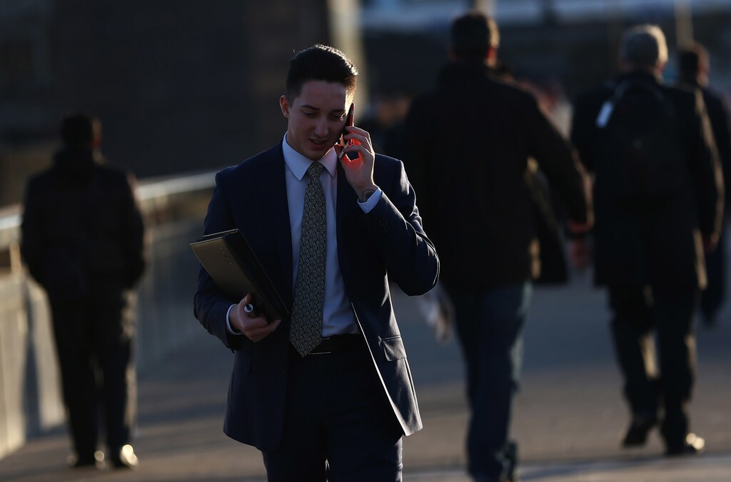 A man speaks on his mobile phone as he walks across London Bridge on the second day of a train strike in London, Britain December 14, 2016. REUTERS/Neil Hall - RTX2V0ZI