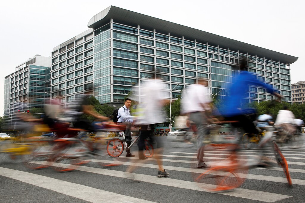 People walk past the headquarters of the ICBC bank in Beijing, China June 12, 2017. Picture taken June 12, 2017. REUTERS/Thomas Peter - RTS19X4O