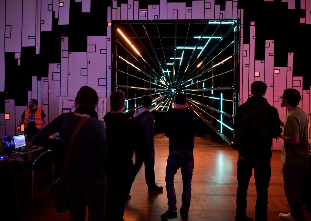 People stand in front of a screen during the 33th Chaos Communication congress, organized by the Chaos Computer Club, in Hamburg, Germany December 28, 2016.
