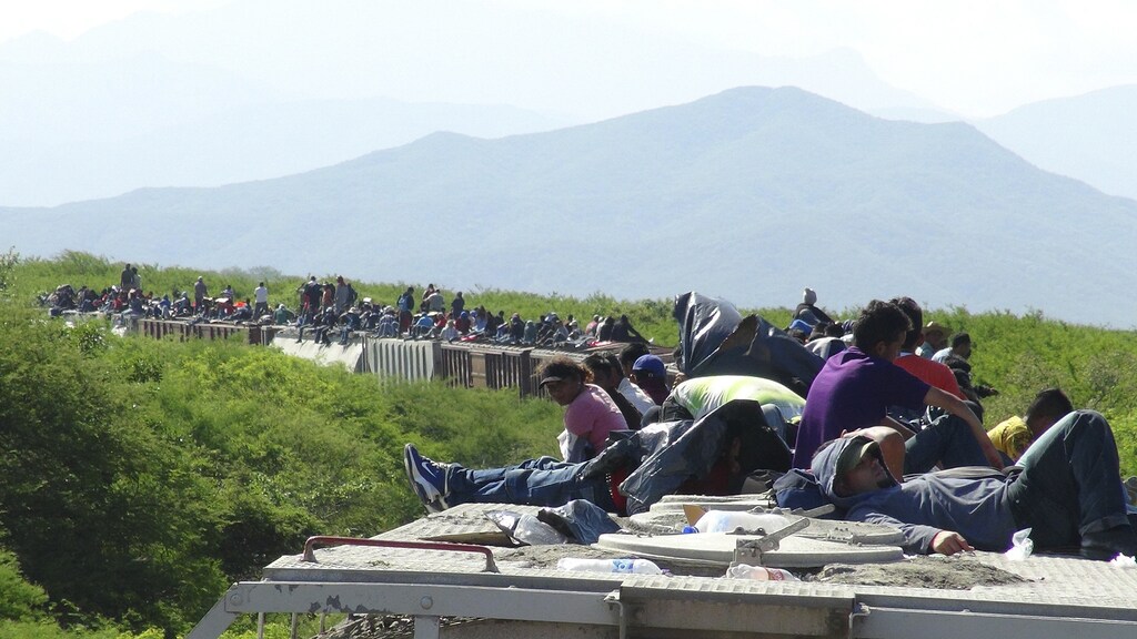 People hoping to reach the U.S. ride atop the wagon of a freight train, known as La Bestia (The Beast) in Ixtepec, in the Mexican state of Oaxaca June 18, 2014. Thousands of young people are hoping to reach the U.S. from their impoverished and violent homes in Central America. In the eight months ended June 15, the U.S. has detained about 52,000 children at the Mexican border, double the figure the year earlier. There's no telling how many have gotten through. Picture taken June 18, 2014.