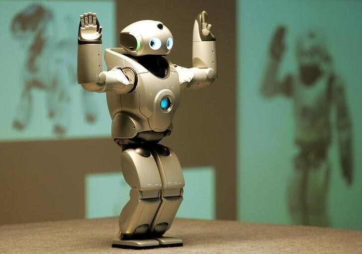 The QRIO, Sony Corp's small bipedal entertainment robot performs a dance during a demonstration in a school in New Delhi October 26, 2004. QRIO has been appointed by NFUAJ as the science messenger to introduce technology and engineering to [children] in an exciting and educational way.