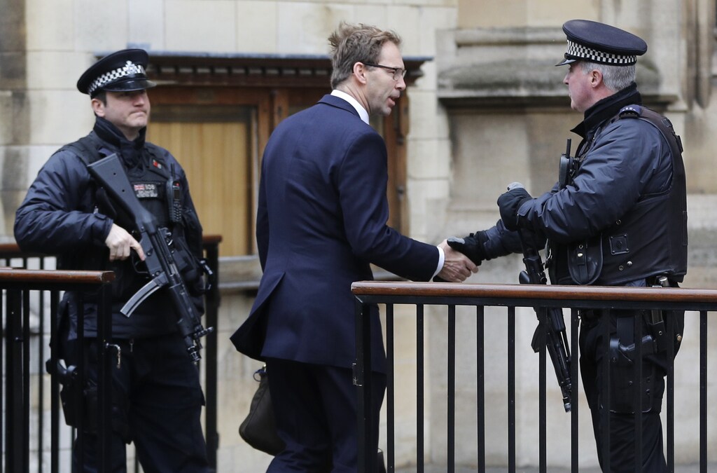 British Member of Parliament Tobias Ellwood shakes hands with an armed police officer as he arrives at the Houses of Parliament, REUTERS/Darren Staples