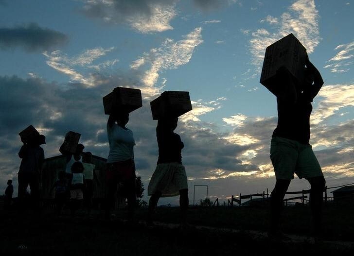 Indigenous Miskitos carry food aid distributed by the World Food Program in the village of Siksayari in Nicaragua, about 625 miles (1005.8 km) north of Managua, December 4,2005. The World Food Program is distributing food aid in indigenous communities after a plague of rats devoured their crops and food stores.