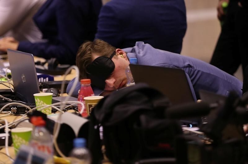 A journalist sleeps while waiting for the end of a European Union leaders summit that aims to select candidates for top EU institution jobs, in Brussels, Belgium July 1, 2019. REUTERS/Yves Herman - RC1563E23B50