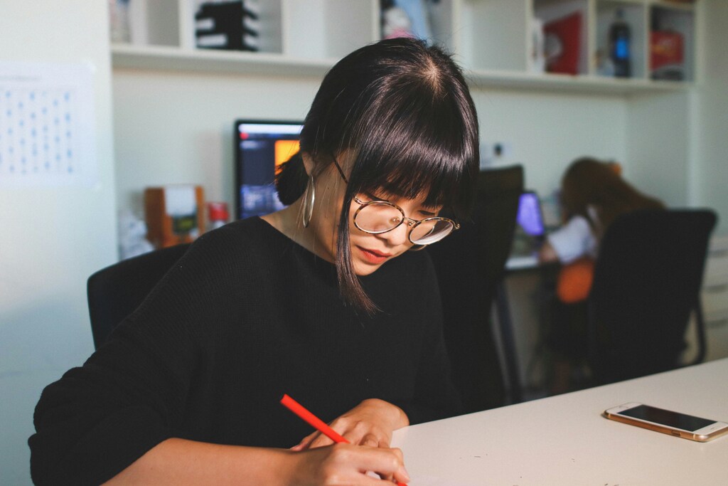 Two women working in an office, illustrating the need to eliminate workplace harassment