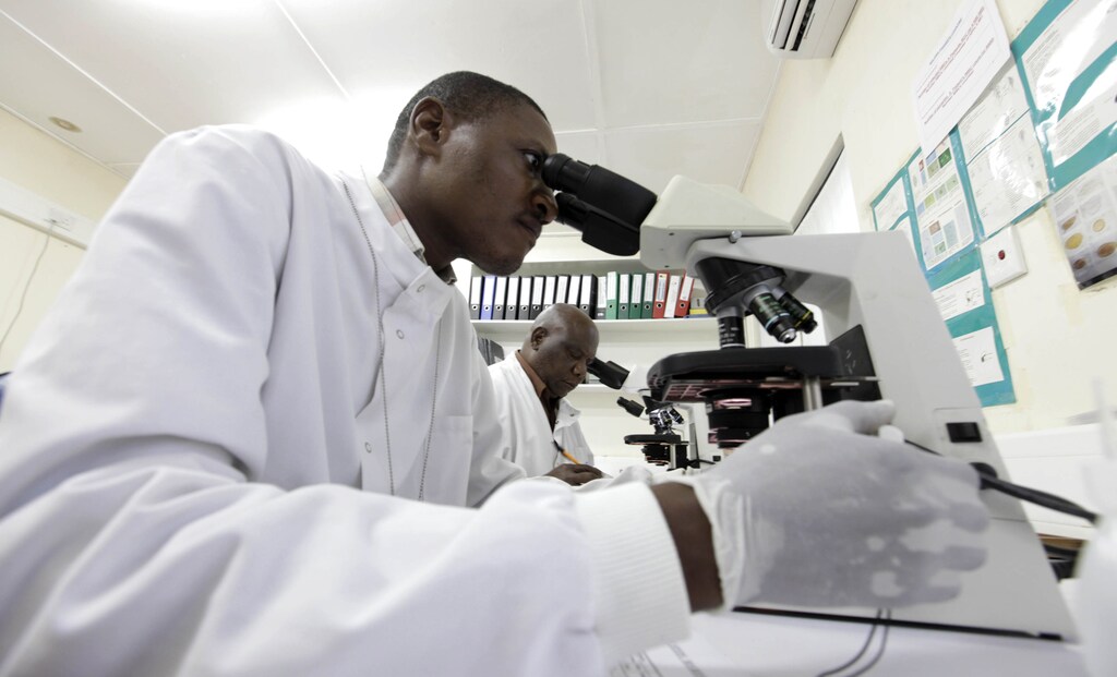 Kenya Medical Research Institute doctors research malaria at the clinical research facility laboratory in the Kenya coastal town of Kilifi, November 23, 2010. Malaria threatens half the people on the planet and kills around 800,000 people a year, many of them too young to have even learned to walk. The death rate has come down in the last decade, but full-scale eradication will cost billions and drag funds away from other equally, or possibly even more urgent health efforts. As governments in poor countries and donors from wealthy ones weigh up where to put their money, experts have begun a quiet but fundamental debate about whether wiping out malaria is realistic or even makes economic sense.Picture taken November 23, 2010. To match Special Report MALARIA/COST REUTERS/Joseph Okanga (KENYA - Tags: BUSINESS HEALTH) - RTXVPM1
