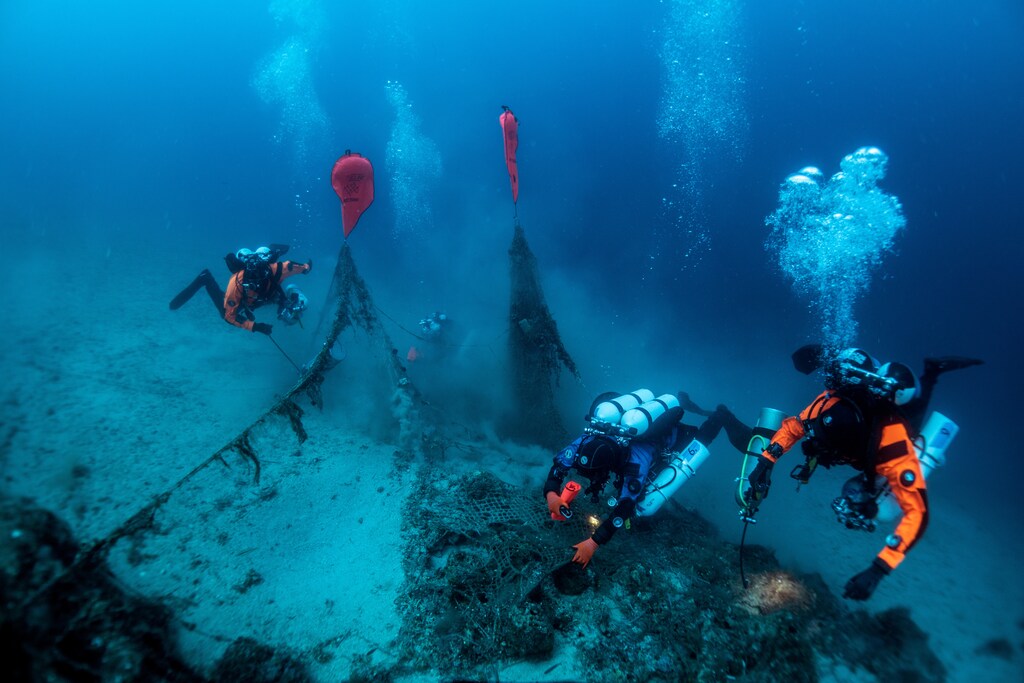 A group of underwater drivers excavate a shipwreck