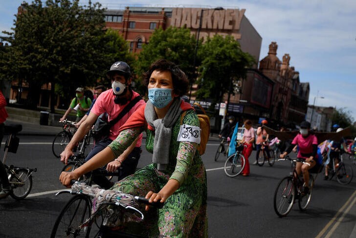 Members of Extinction Rebellion take part in a socially distanced bicycle ride to campaign for more cycling and cycle lanes and fewer vehicles on the roads, following the outbreak of the coronavirus disease (COVID-19), London, Britain, May 17, 2020. REUTERS/Toby Melville