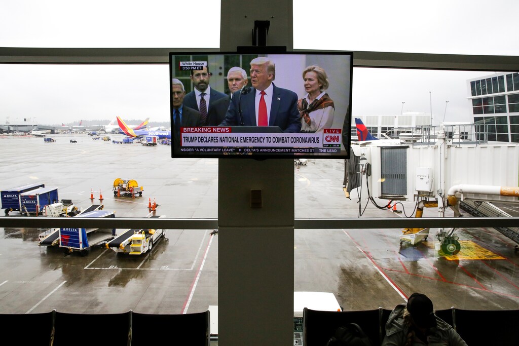 U.S. President Donald Trump is pictured on a television at Seattle-Tacoma International Airport as he declares a national emergency over the coronavirus, in SeaTac Washington, U.S. March 13, 2020. REUTERS/Jason Redmond - RC2AJF9Y9YE0