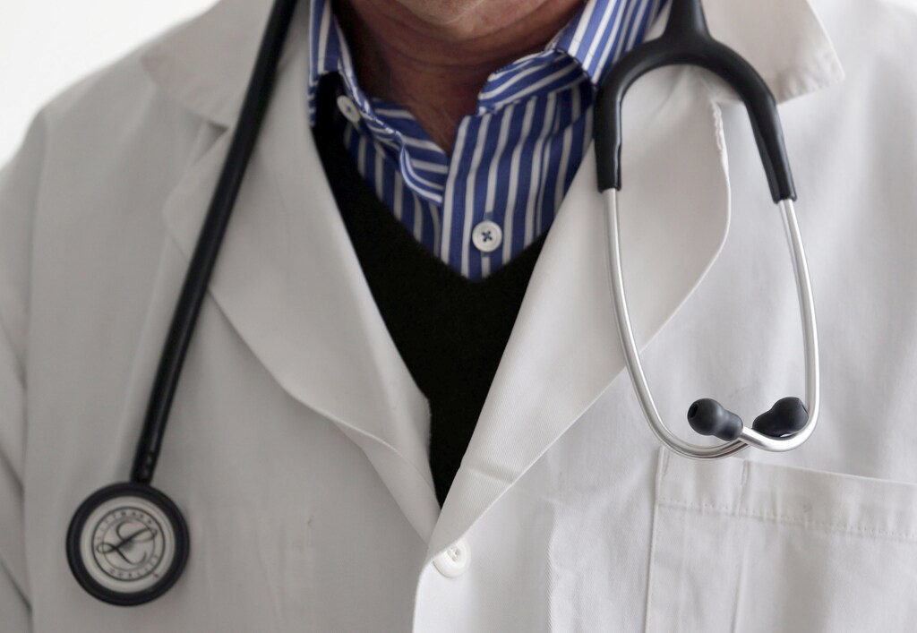 A photo illustration shows a French general practitioner with a stethoscope in a doctor's office in Bordeaux January 7, 2015. French physicians protest against a new health reform bill that would introduce a third party payment system. Picture taken January 7, 2015. REUTERS/Regis Duvignau (FRANCE - Tags: HEALTH POLITICS) - PM1EB171G3V01