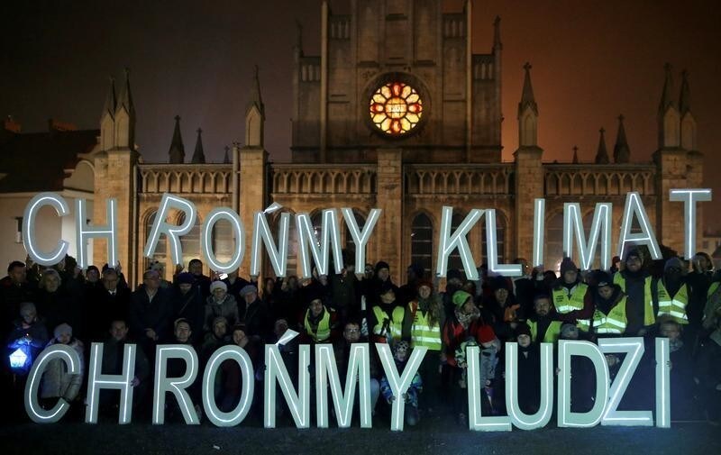 Environmental activists hold letters 'Save the climate, save the people' during the COP24 U.N. Climate Change Conference 2018 in front of the church in Imielin near Katowice, Poland December 6, 2018. Agencja Gazeta/Grzegorz Celejewski via REUTERS ATTENTION EDITORS - THIS IMAGE WAS PROVIDED BY A THIRD PARTY. POLAND OUT. NO COMMERCIAL OR EDITORIAL SALES IN POLAND. - RC1F5B745EC0