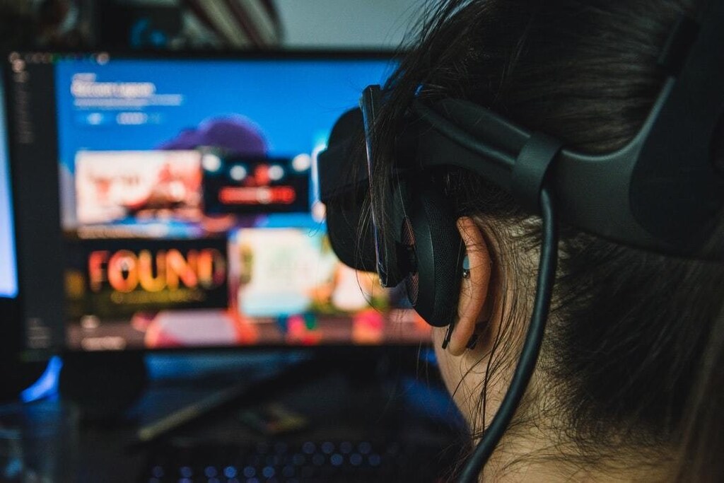 A woman wears a headset as she explores a virtual world.