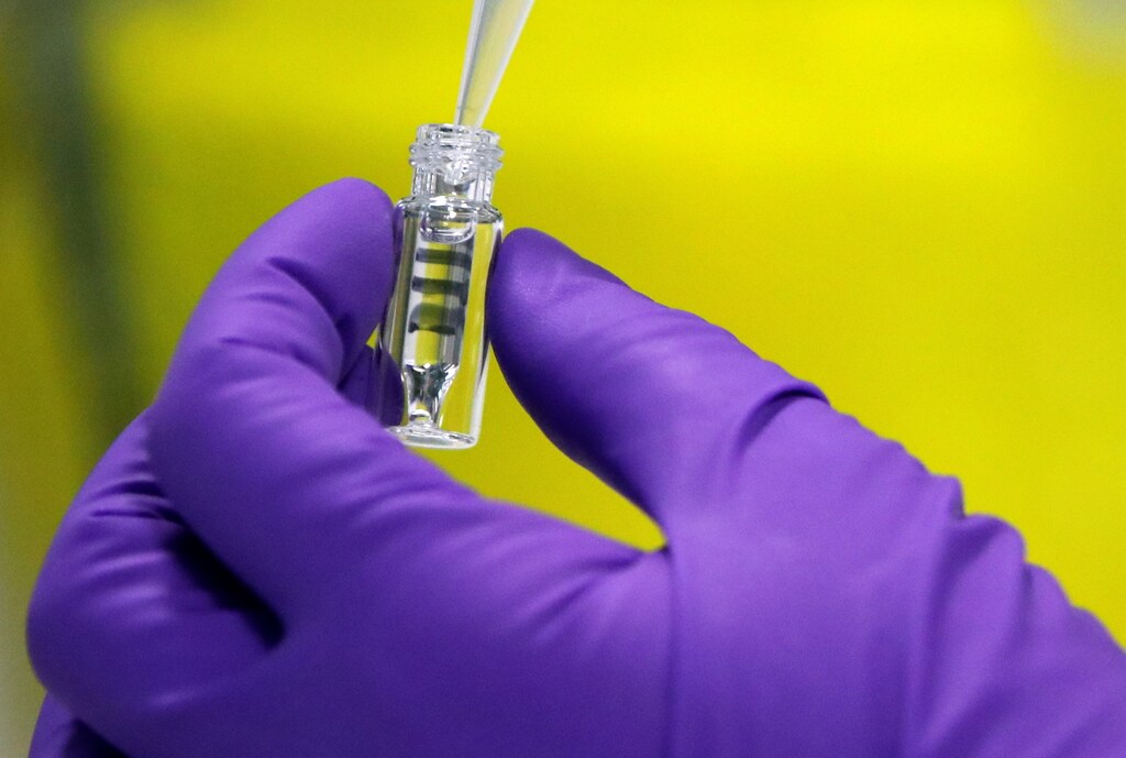 A laboratory operator proceeds a manipulation as part of the manufacture of the COVID-19 DNA Vaccine INO-4800 at biotech company Kaneka Eurogentec facility in Liege, Belgium December 8, 2020.