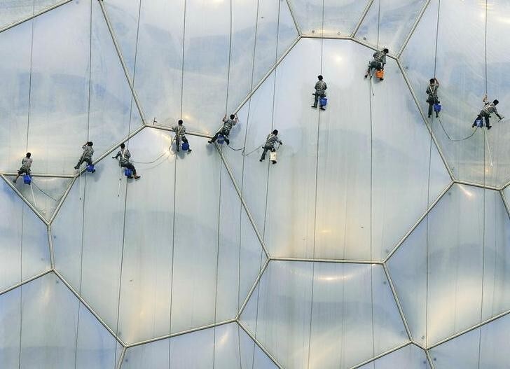 Workers clean the exterior of the National Aquatics Center, also known as the Water Cube, at the Olympic Green in Beijing, July 18, 2008. With less than a month to go to the Olympics, Beijing and neighbouring provinces have asked polluting industries to shut or reduce production to clean the air for athletes, and to help offset a looming power shortage. REUTERS/Ge Gong (CHINA) (BEIJING OLYMPICS 2008 PREVIEW)