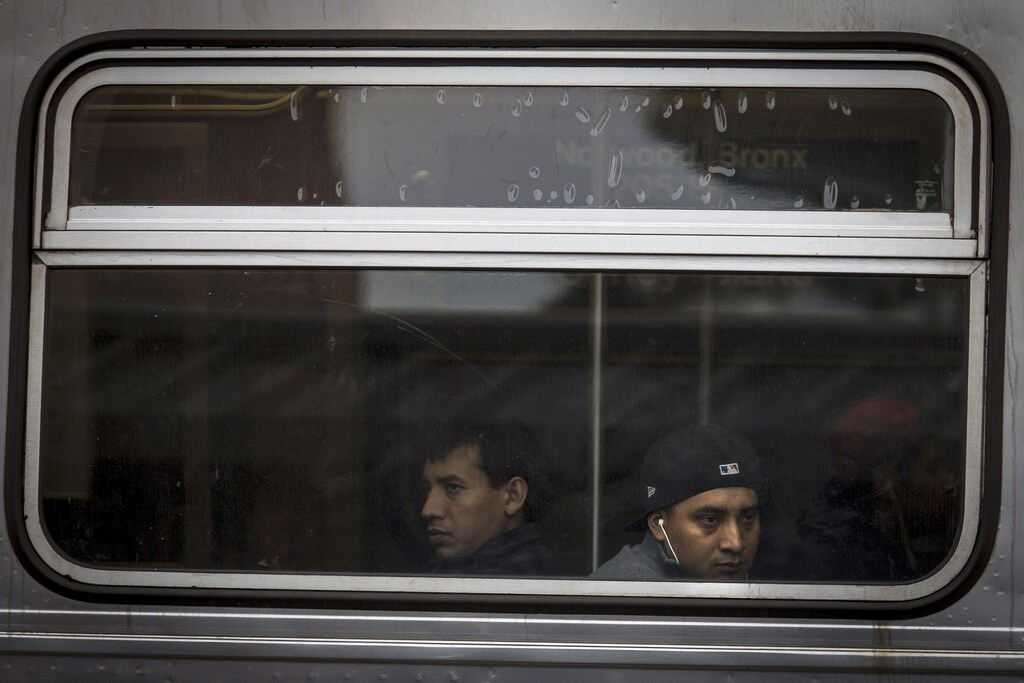 People are photographed through the window as they ride the D train subway heading toward Coney Island in the Brooklyn borough of New York October 3, 2015.