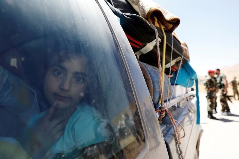 A Syrian refugee girl who left Lebanon looks through a window as she arrives in Qalamoun, Syria June 28, 2018. REUTERS/Omar Sanadiki TPX IMAGES OF THE DAY - RC1BCFC3D780