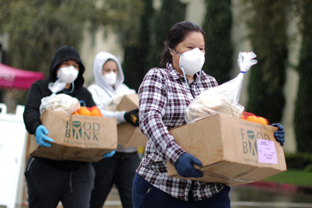 People pick up fresh food at a Los Angeles Regional Food Bank giveaway.