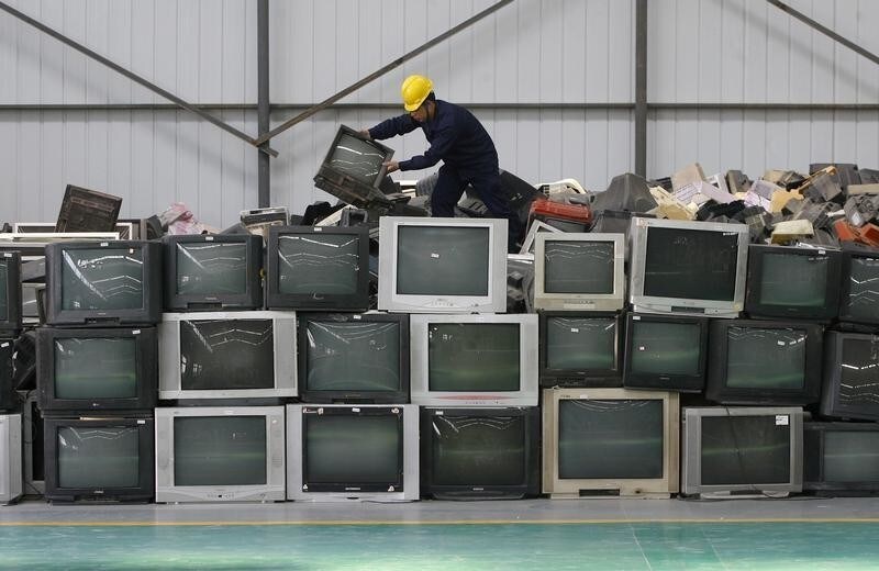 An employee arranges discarded televisions at a newly opened electronic waste recycling factory in Wuhan, Hubei province March 29, 2011. According to the U.S. Environmental Protection Agency (EPA), e-waste is the fastest growing commodity in the waste stream, with a growth rate five times that of other parts of the business such as industrial waste. The burgeoning middle classes in fast-growth China and India mean there are more computers and mobiles, adding to e-cycling growth. REUTERS/Stringer (CHINA - Tags: ENVIRONMENT BUSINESS SCI TECH IMAGES OF THE DAY) CHINA OUT. NO COMMERCIAL OR EDITORIAL SALES IN CHINA - GM1E73T1GZH01
