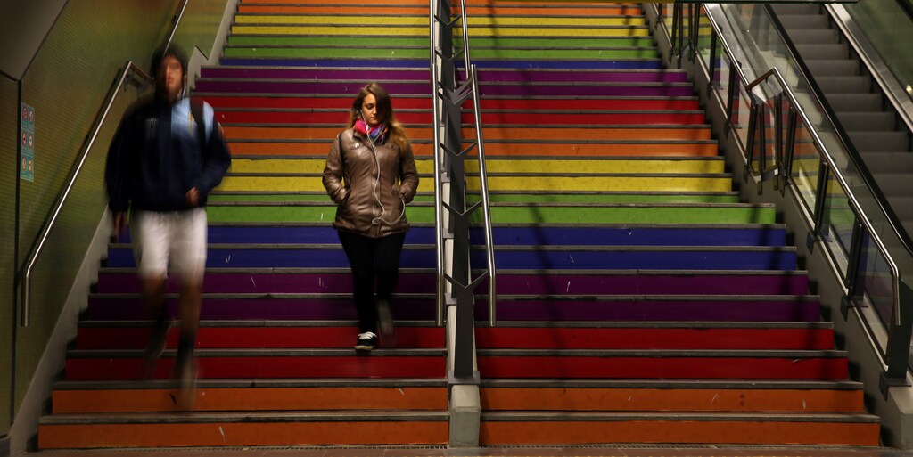 A woman and a man walk down the stairs painted in the colors of the rainbow at a subway station to celebrate International Day Against Homophobia in Buenos Aires, Argentina, May 17, 2017. REUTERS/Marcos Brindicci - RC1C1F074710