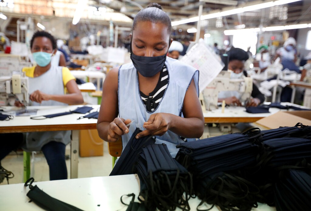 Workers make face masks at a local clothing manufacturer after it switched part of its production from clothing exports to making protective masks, amidst the coronavirus disease (COVID-19) outbreak, in Port-au-Prince, Haiti April 21, 2020. REUTERS/Jeanty Junior Augustin - RC2A9G9H7NK6