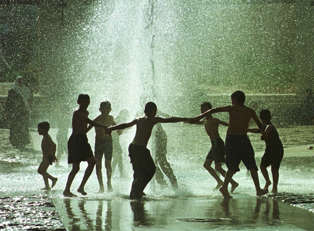 Young Jordanians splash and play in a public fountain in the centre of Amman July 29,2000 as hundreds of local citizens rushed to cool down in public swimming pools as a heat wave struck the kingdom where temperatures reached 42 degrees Celsius, at least 9 nine degrees above the national average for the time of the year.