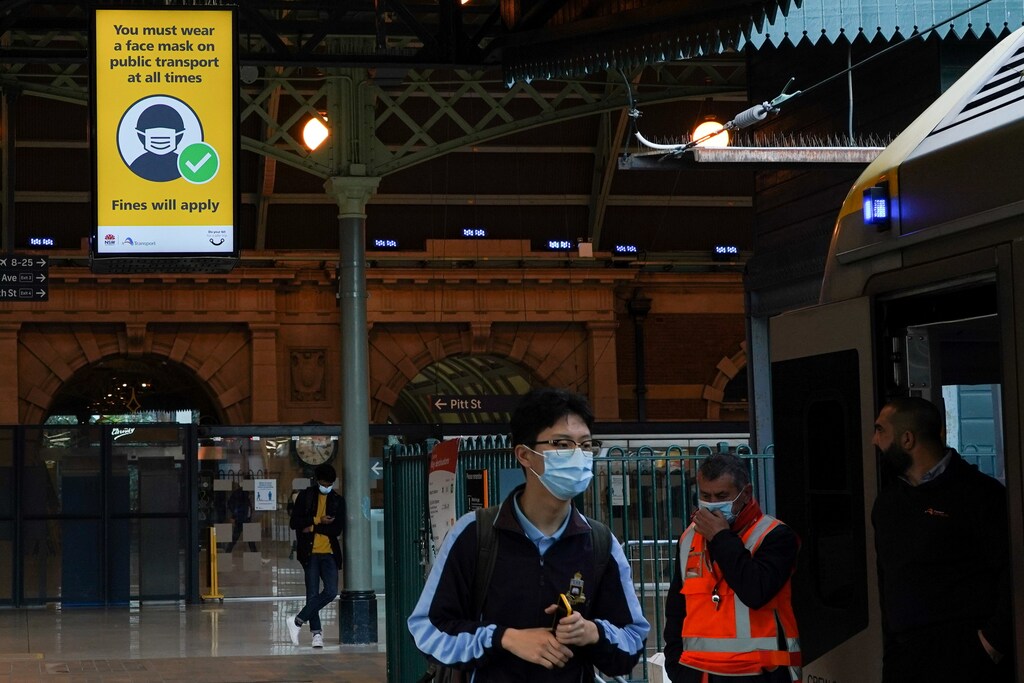 A sign at Central Station notes the implementation of new public health regulations from the state of New South Wales, as the city grapples with an outbreak of the coronavirus disease (COVID-19) in Sydney, Australia, June 23, 2021. REUTERS/Loren Elliott - RC256O9SJ188