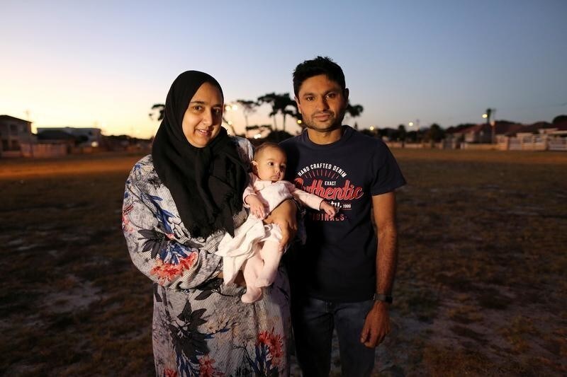 Ferzanah Essack, 36, a software developer and her husband Hassan Essack, 37, a software developer, pose for a portrait with their 4.5-month-old baby Salma on the morning of Ferzanah's first day back to work, in Cape Town, South Africa, February 18, 2019. South African labour law allows mothers to take four months of consecutive maternity leave although employers are not obliged to pay employees during this time. Ferzanah was on leave for five months in total - four months maternity leave, two weeks annual leave and two more weeks of unpaid leave. She says six to seven months would be more reasonable amount of maternity leave. Hassan took 10 days off. "I think paternity leave should be longer. 10 days isn't enough. Fathers also need time to bond with the newborns." Ferzanah said she is nervous and a bit scared about leaving baby Salma and returning to work. "Nervous, very nervous, scared little bit, but I think I'm ok, I'm ok, I'll survive," she said of leaving her baby to go to work. Grandparents will be taking care of the baby while parents are at work. "We pay (for childcare) in love and kisses", she said. "With lots of love, because it's the grannies," Ferzanah said. REUTERS/Sumaya Hisham SEARCH "MOTHERS GLOBAL" FOR THIS STORY. SEARCH "WIDER IMAGE" FOR ALL STORIES. - RC1E82B69010