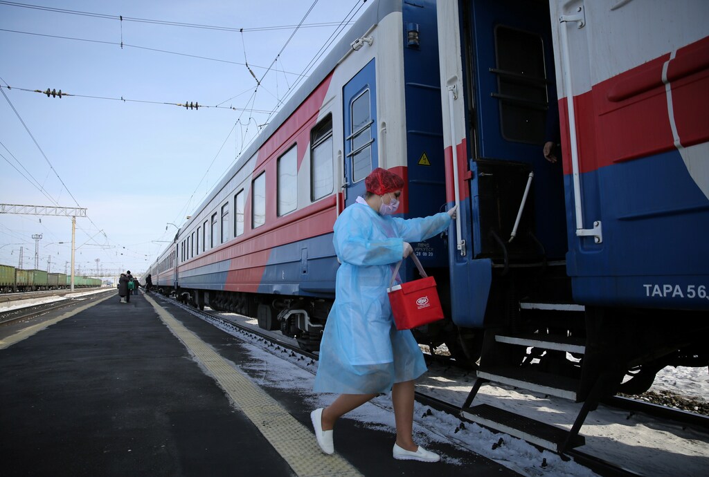 A medical worker carries a bag containing doses of the Sputnik V (Gam-COVID-Vac) vaccine against the coronavirus disease (COVID-19) as she enters a carriage of the Academician Fyodor UglovÂ medical train, at a railway station in the town of Tulun in Irkutsk Region, Russia March 16, 2021. REUTERS/Evgeny Kozyrev - RC2GCM96JYV1