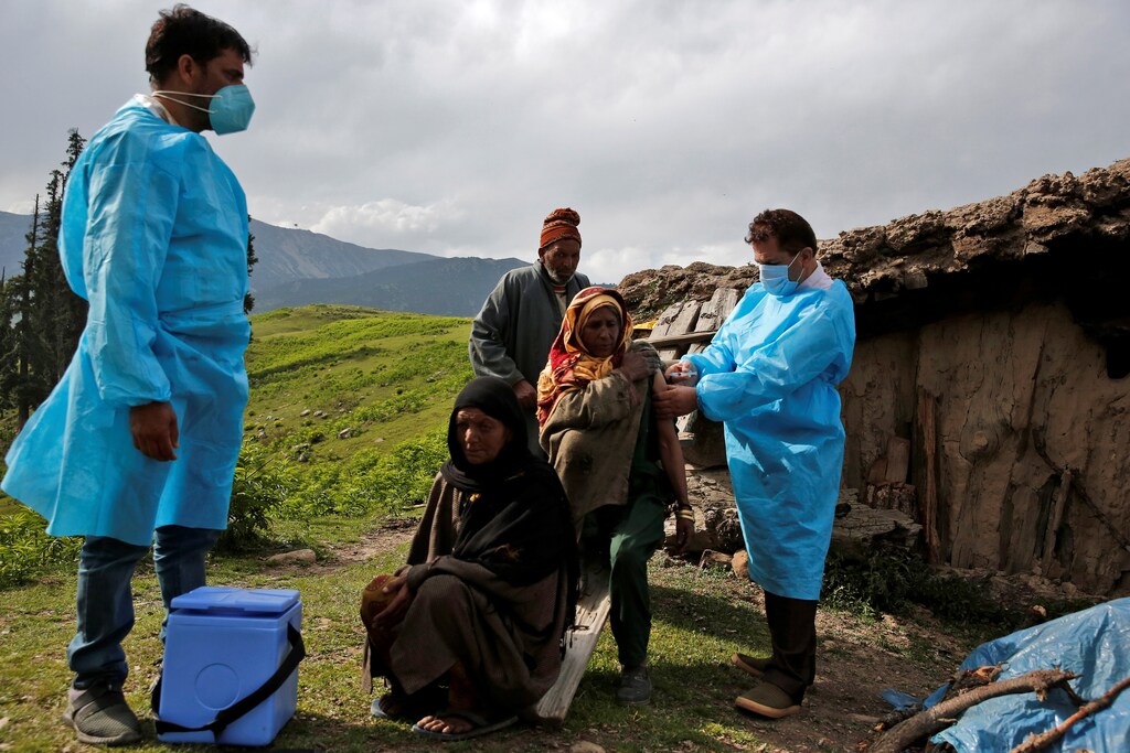 A shepherd woman receives a dose of COVISHIELD, a coronavirus disease (COVID-19) vaccine manufactured by Serum Institute of India, during a vaccination drive at Tosa Maidan in central Kashmir's Budgam district in India. June 21, 2021.
