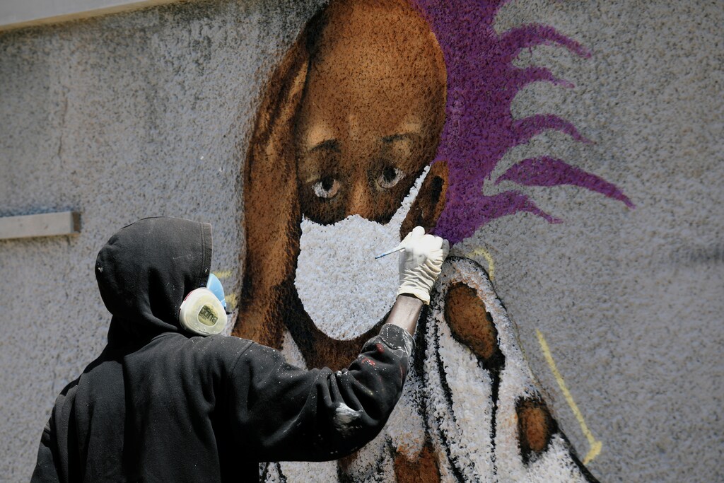 Serigne Boye aka Zeus, a graffiti artist from RBS crew works on his mural to encourage people to protect themselves amid the outbreak of the coronavirus disease (COVID-19), in Dakar, Senegal March 25, 2020. Picture taken March 25, 2020. REUTERS/Zohra Bensemra - RC2BSF9EKZX1