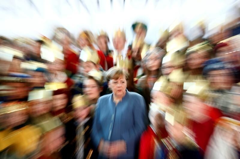 Acting German Chancellor Angela Merkel attends a reception for Sternsinger (carol singers) at the Chancellery in Berlin, Germany, January 8, 2018. REUTERS/Hannibal Hanschke - RC1634F407D0