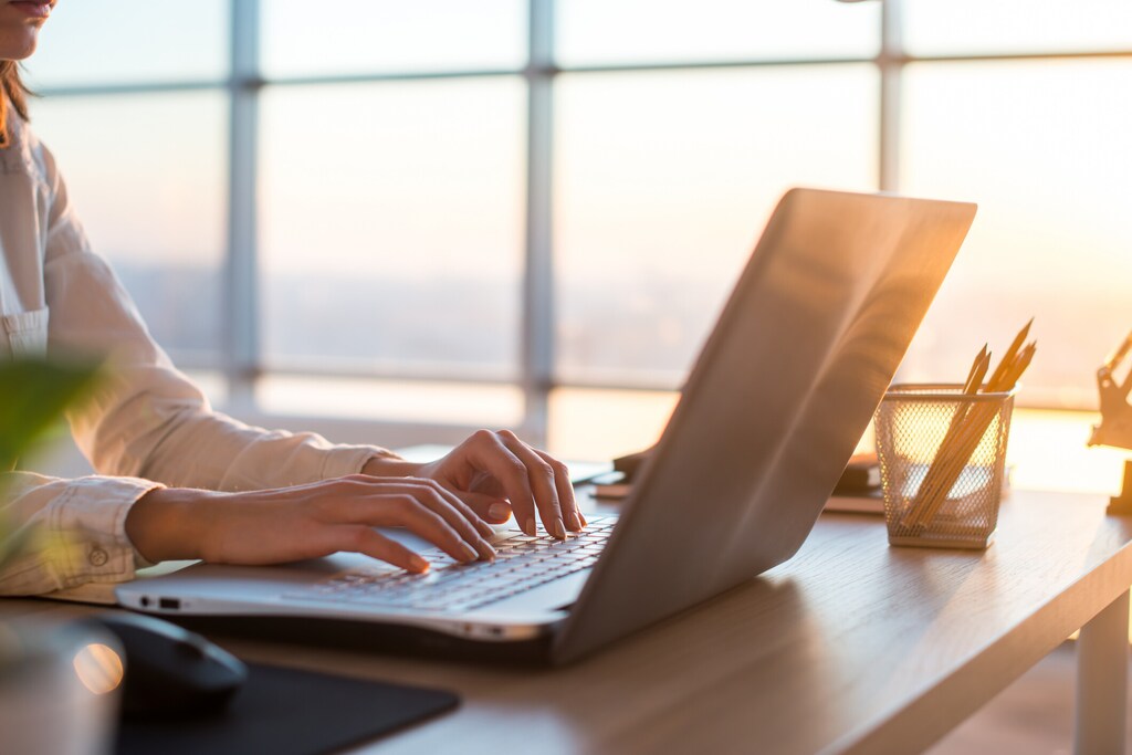 Adult businesswoman working at home using computer, studying business ideas on a pc screen on-line; AI in education