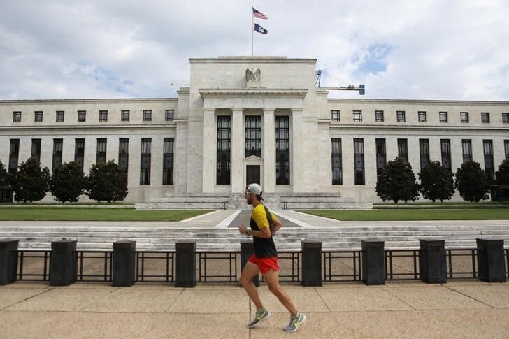 A jogger runs past the Federal Reserve building in Washington, DC, U.S., August 22, 2018. REUTERS/Chris Wattie