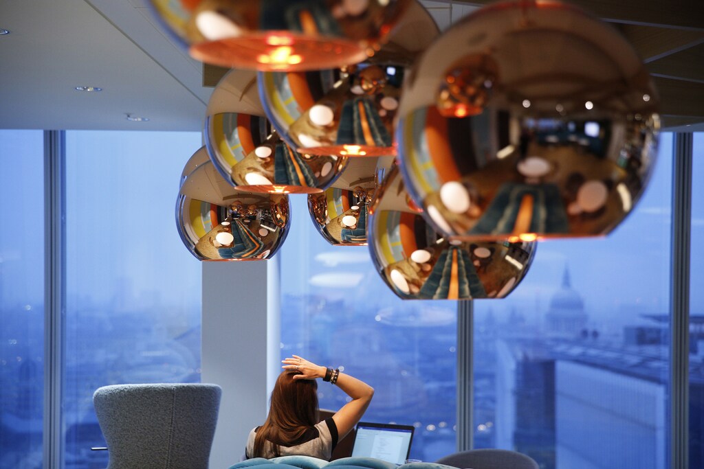 A worker takes in a view of St Paul's cathedral as she works in the bar of the Jellyfish office space in London, Britain December 19, 2016. Picture taken December 19, 2016. REUTERS/Neil Hall - LR1ECCM0ZH5HZ