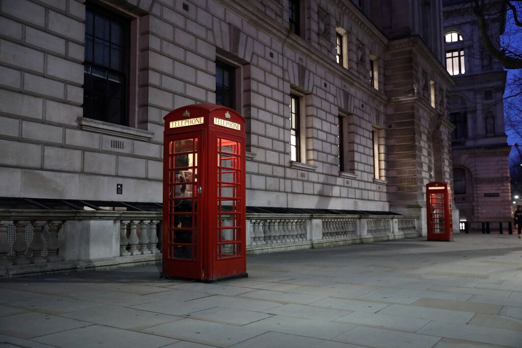 Red telephone boxes stand in an empty street in Whitehall in London, Britain March 12, 2020.