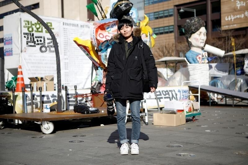Jeung Un, 27, a freelance photographer, poses for a portrait at a site which protesters have occupied, in central Seoul, South Korea, February 23, 2017. "Most news outlets prefer to employ male photographers. I feel strongly about gender inequality. When I cover violent scenes, sometimes I am harassed and hear sexually-biased remarks," Un said.