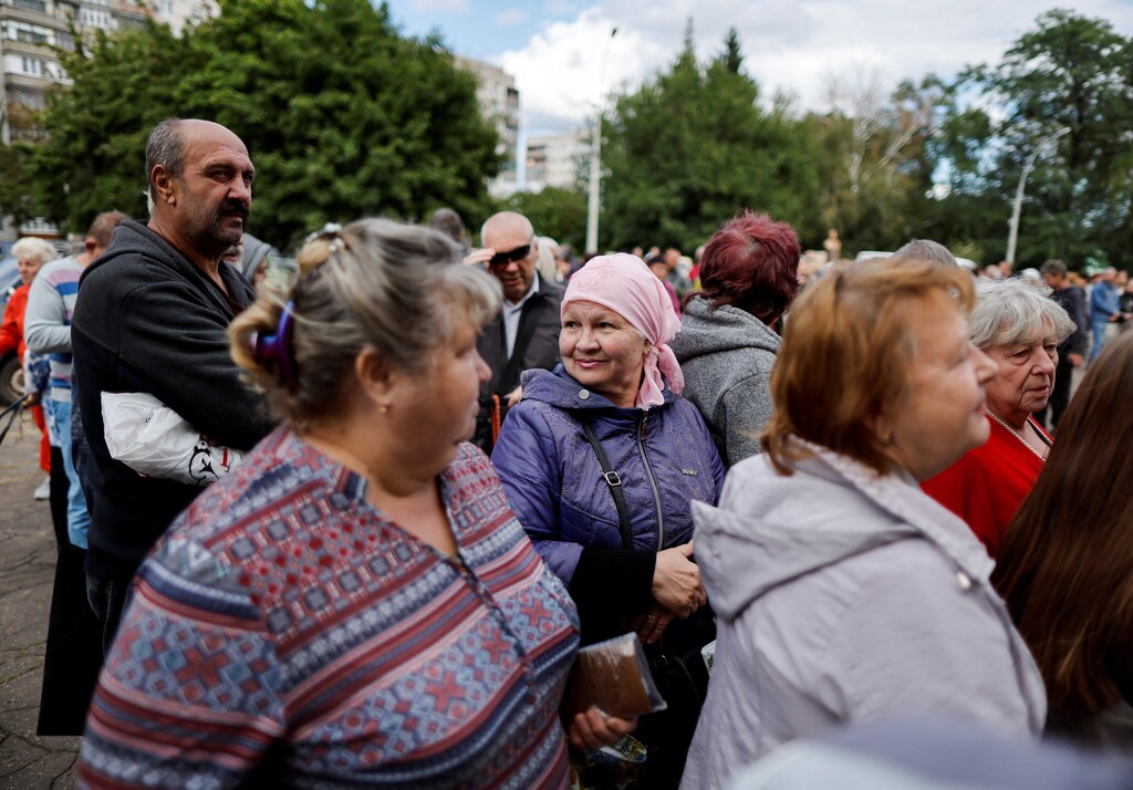 People line up to receive humanitarian help organized by the municipality and the World Food Program, amid Russia's invasion, in Kramatorsk, Donetsk region, Ukraine, September 6, 2022. REUTERS/Ammar Awad