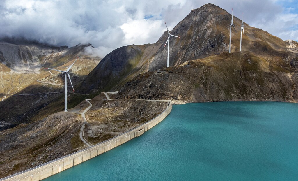 Windmills are seen in front of the Gries dam at SwissWinds farm, Europe's highest wind farm at 2500m, near the Nufenen Pass in Gries, Switzerland, September 2, 2022. REUTERS/Denis Balibouse